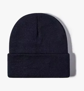 Close-up detail of dark blue ribbed knit fabric, soft warm wool winter beanie texture.