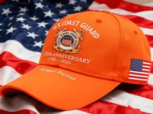 Orange US Coast Guard 235th Anniversary embroidered baseball cap with American flag patch.