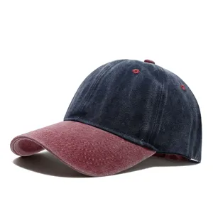 Close-up detail of vintage washed denim baseball cap with contrasting color curved brim.