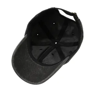 Detailed interior view of a washed black cotton baseball cap with adjustable metal buckle.