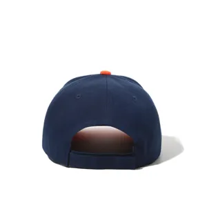 Detail view of navy blue baseball cap back with orange top button and adjustable velcro strap.