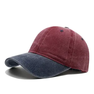 Detailed close-up of the two-tone washed denim baseball cap showing vintage distressed fabric.