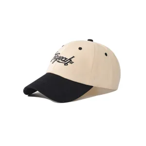 Detailed shot of the two-tone embroidered baseball cap with classic curved brim and soft crown.