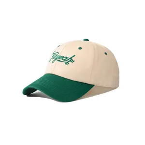 Detail view of a two-tone baseball cap with green embroidery and curved brim for casual wear.