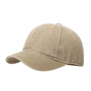 Close-up detail of vintage washed short brim baseball cap, soft crown canvas texture.
