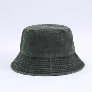 Vintage washed bucket hat detail, classic grey cotton fabric with fine stitching.