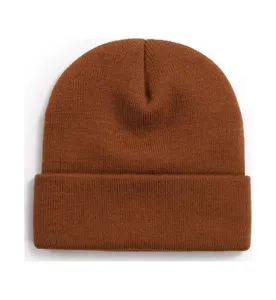 Detail view of brown winter knitted beanie, cozy ribbed cuff cold hat, soft texture closeup.