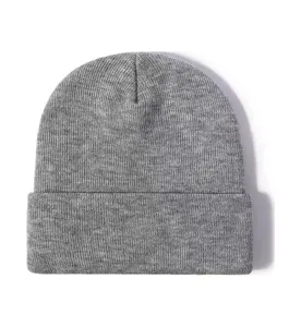 Solid color knitted beanie for winter warmth, classic rolled brim cold hat, plain design.