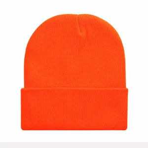 Close-up of vibrant orange cuffed knitted beanie detail, showing soft winter warm texture.