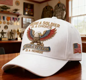 Close-up view of a white baseball cap with embroidered eagle graphic and patriotic wording.