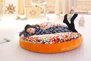 Giant plush donut pillow with colorful sprinkles, soft cushion for home decor and office nap.