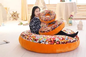 Giant donut bean bag chair and plush cushion set, soft creative home decor and comfortable nap pillow.
