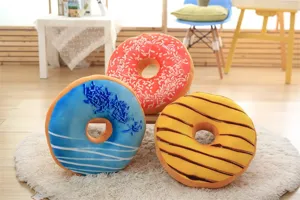 Soft plush donut pillow detail showing colorful sprinkles and realistic textured fabric.