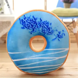 Detailed view of the cute blue donut plush pillow, soft texture with colorful sprinkles.