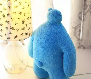 Cute blue plush bear doll with small head and big body, soft stuffed toy for kids and home decor.