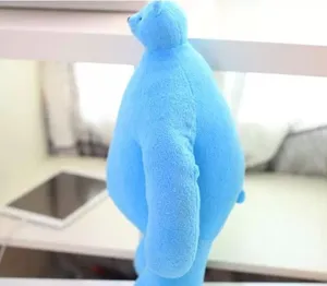 Blue plush bear toy detail view, cute cartoon stuffed animal with big body and small head.