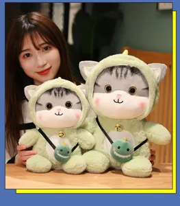 Cute plush cat doll in green dinosaur costume with cute cross-body bag. Soft and cuddly.