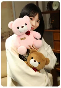 Cute sitting teddy bear plush toy with rose flower for Valentine's Day gift detail shot