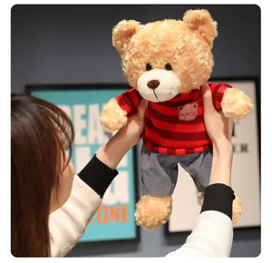 Cute curly teddy bear plush toy wearing a red striped sweater and grey pants for kids.