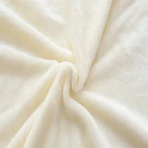 Close-up view of soft beige plush fabric texture, showing smooth and comfortable fluffy surface.