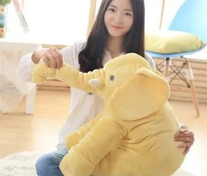 Detailed view of soft yellow elephant plush toy, cute stuffed animal pillow for kids.