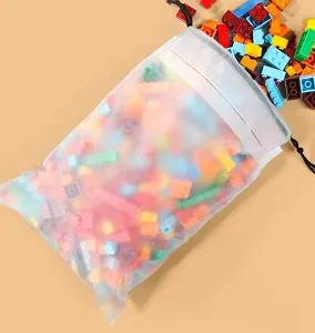 Close-up of frosted transparent plastic drawstring storage bag with colorful blocks