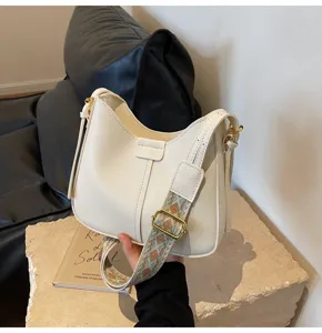 Korean style high-end versatile bucket bag with wide strap and shoulder cross-body design.