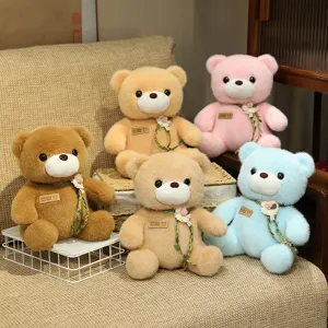 Cute sitting teddy bear plush toy with rose vine decor, soft doll gift for girls and kids.