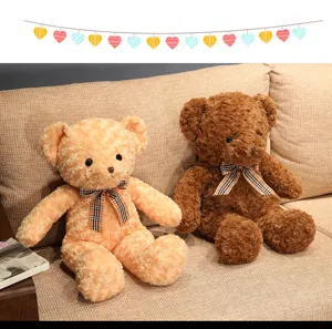 Joli ours en peluche avec nœud papillon à carreaux, doudou doux pour cadeau d'enfants.