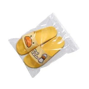 Yellow cute cartoon duck print slippers in clear plastic zip storage bag for daily home wear