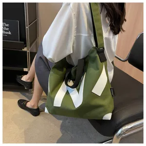 Large capacity canvas tote shoulder bag for women, casual commuter handbag with strap.