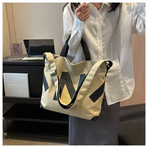 Large capacity canvas tote bag for women, stylish crossbody handbag with shoulder strap.