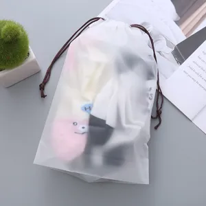 Frosted PE drawstring storage bag, translucent waterproof travel organizer for socks and toys.