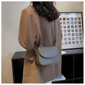 Detailed view of minimalist Korean style crossbody shoulder bag for women, chic grey design.
