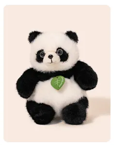 Cute plush panda toy with green leaf tag, soft stuffed animal doll detail view.