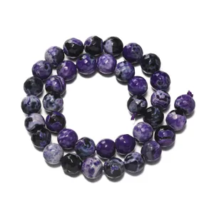 Close-up detail of faceted purple fire agate gemstone beads for DIY jewelry making and crafting.