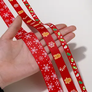 Close-up detail of red Christmas grosgrain ribbon featuring cute snowflake and gingerbread designs.