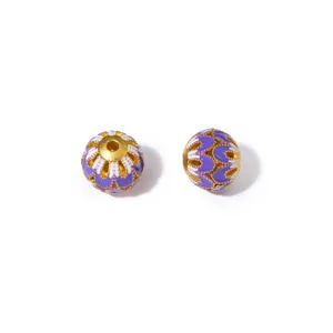 Detailed close-up view of vintage gold-plated enamel flower beads for DIY crafts.