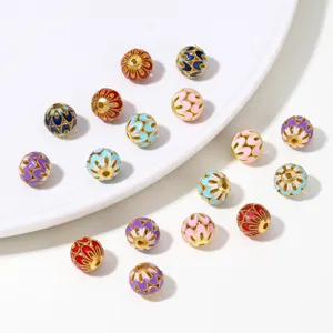 Close-up detail of colorful enamel cloisonne beads with gold plating, perfect for DIY jewelry making.