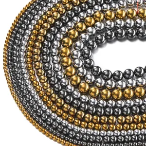Close-up detail of magnetic hematite round beads in gold and silver, ideal for DIY jewelry.