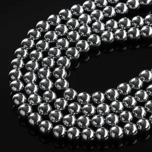 Close-up of polished electroplated silver metallic magnetic hematite beads for DIY jewelry.