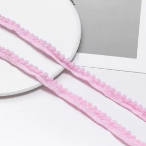 Pink pom-pom fringe trim polyester ribbon for DIY doll clothes sewing and craft decor details.