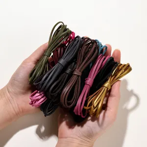 Detalle del cordón de ante sintético plano en varios colores para hacer joyería DIY.