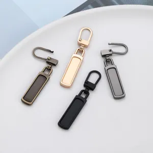 Metal detachable zipper pulls, tool-free replacement hardware for backpacks and coats.