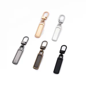 Detailed shot of metal detachable zipper pullers in various metallic finishes for repair.