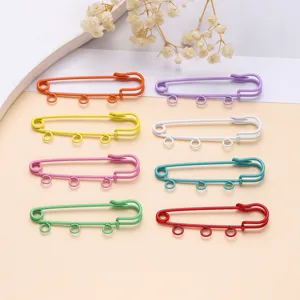 Colorful 3-hole safety pins for DIY brooch and clothing bag accessories detail view.