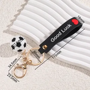 Mini football keychain sports fan bag pendant with silicone strap and metal ring.