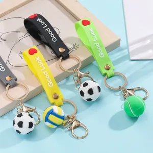 Close-up of cute mini sports ball keychains with silicone straps and metal hooks for bags.