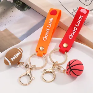 Silicone sports ball keychain set featuring mini basketball and football with Good Luck strap.