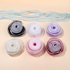 Detailed view of colorful organza ribbons with delicate pearl edges for DIY crafts and decor.